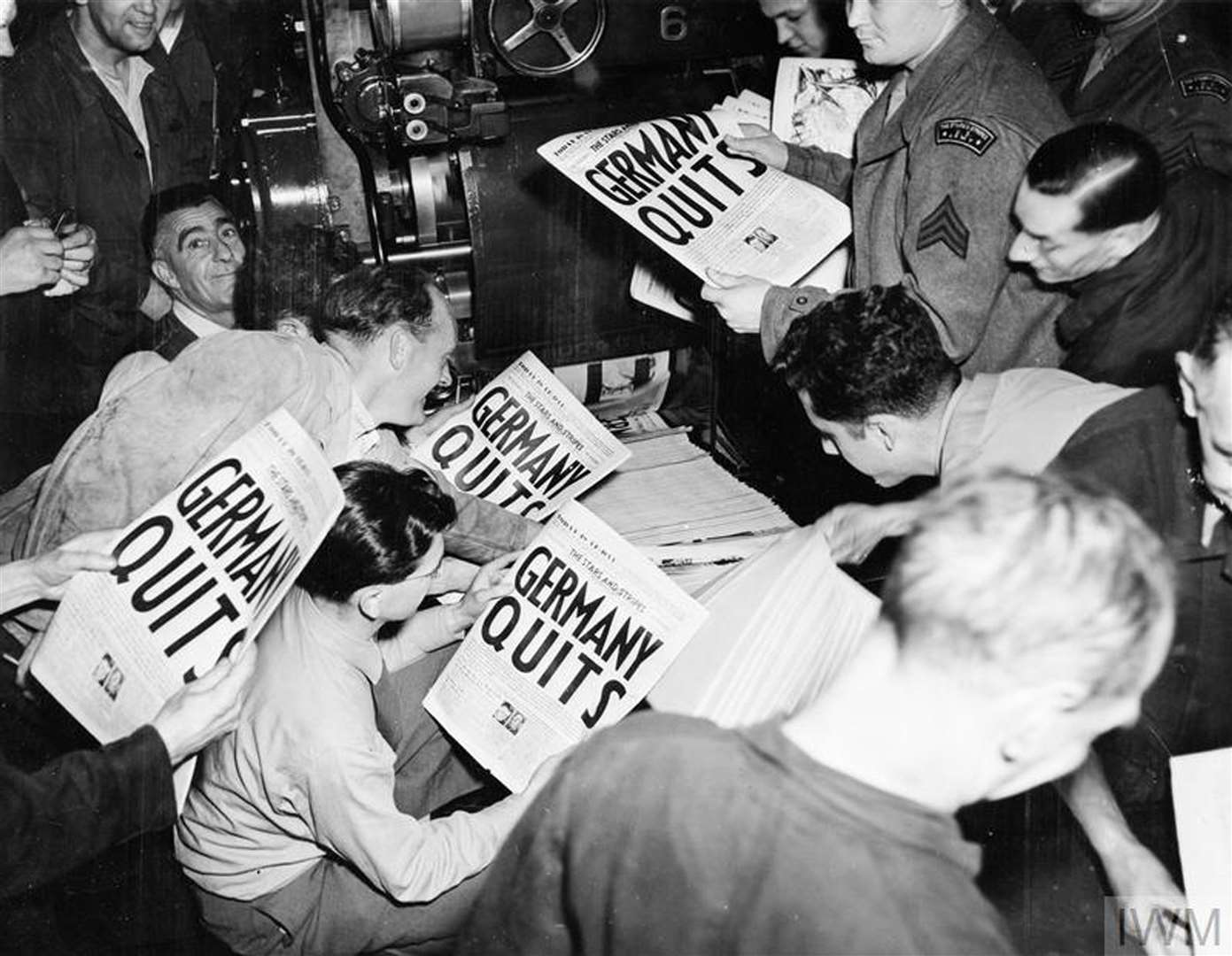 Soldiers pulling copies of Stars And Stripes from the press of the London Times on May 7 1945 (Imperial War Museum/PA)