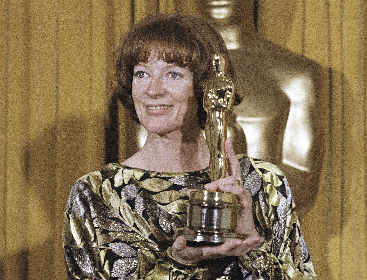 Dame Maggie Smith holds her Oscar for best supporting actress in California Suite in 1979 (Reed Saxon/AP/PA)