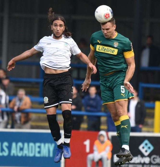 Dover's Nassim L'Ghoul, left, makes an aerial challenge against Notts County's Ben Turner