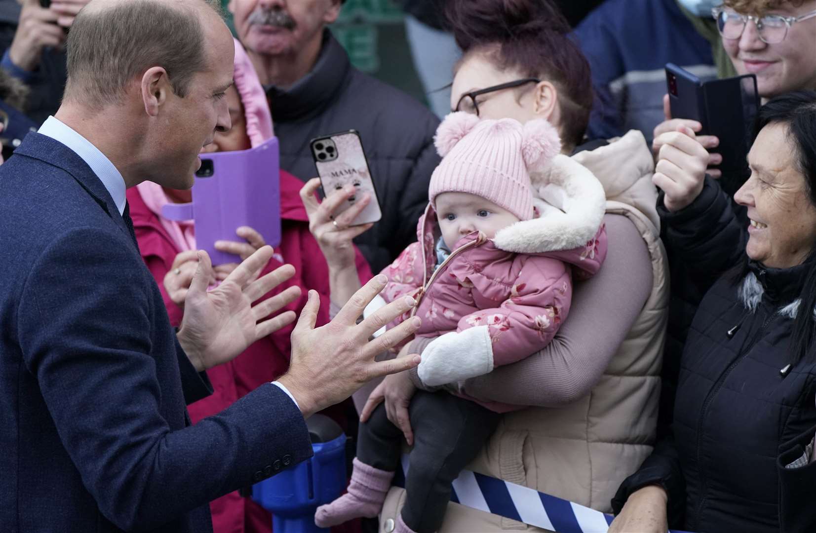 The Prince of Wales meets onlookers during a visit to Holyhead Marina Cafe and Bar in Holyhead, Wales (Danny Lawson/PA)