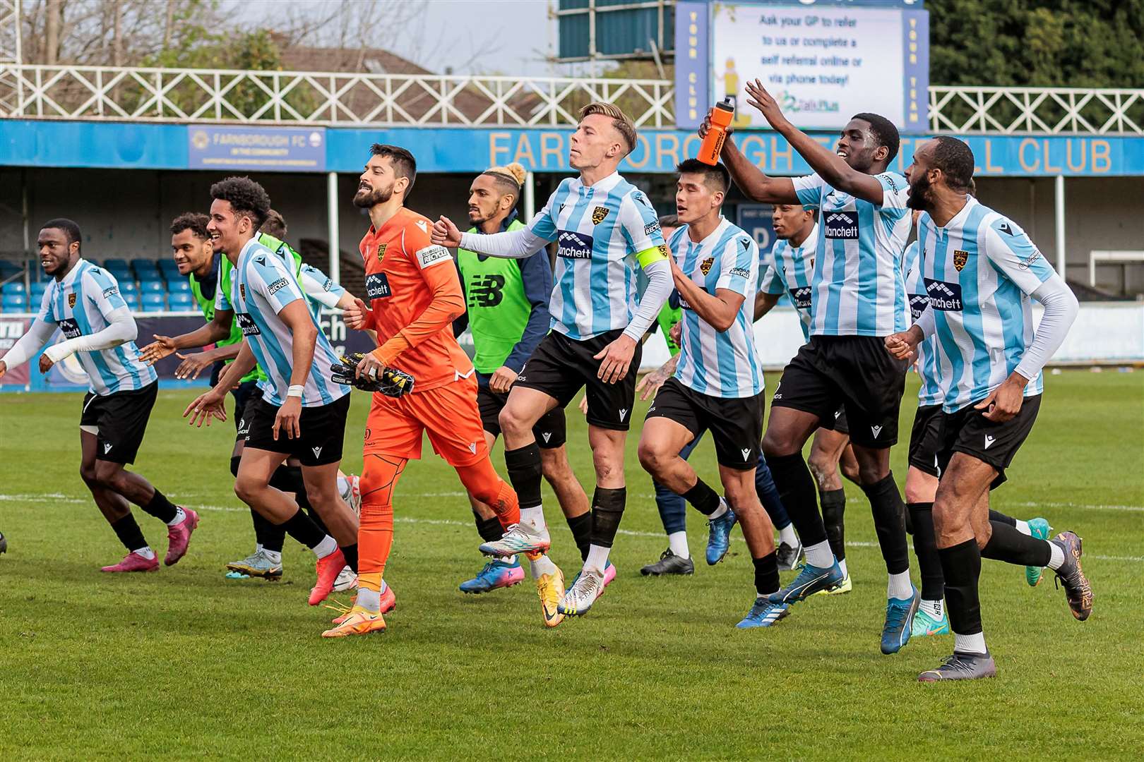 Maidstone players celebrate with travelling fans after the win that sealed a play-off place. Picture: Helen Cooper