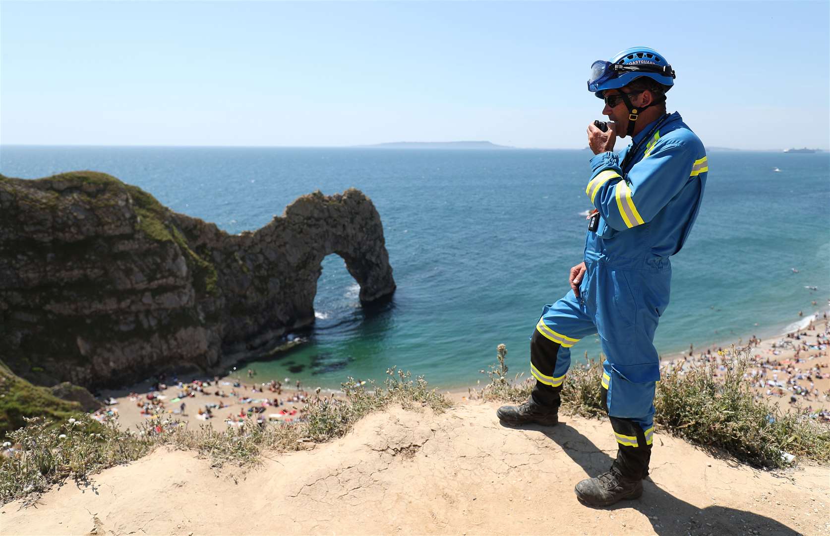 A member of the coastguard looks over a packed beach (Andrew Matthews/PA)