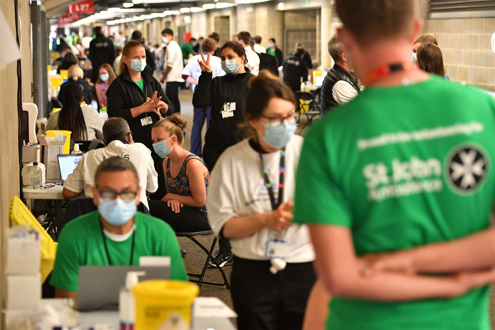 People queue to receive a coronavirus vaccination at Twickenham (Dominic Lipinski/PA)