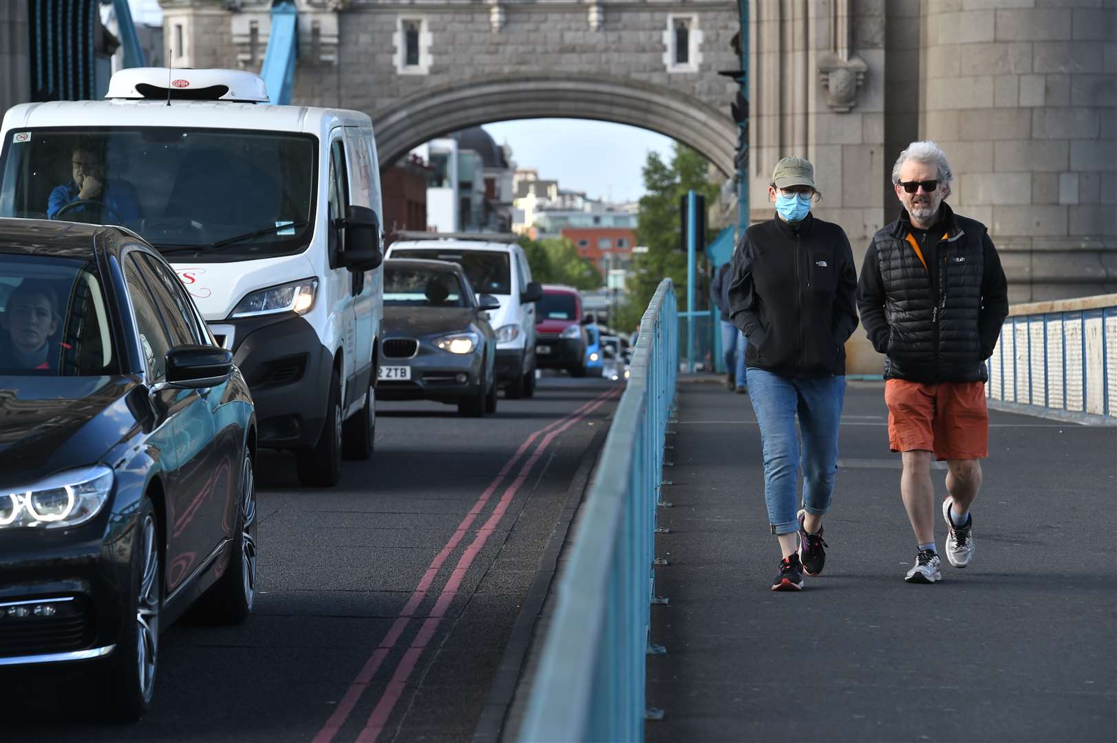 Pedestrians walk alongside heavy traffic passing over Tower Bridge in London (Kirsty O’Connor/PA)