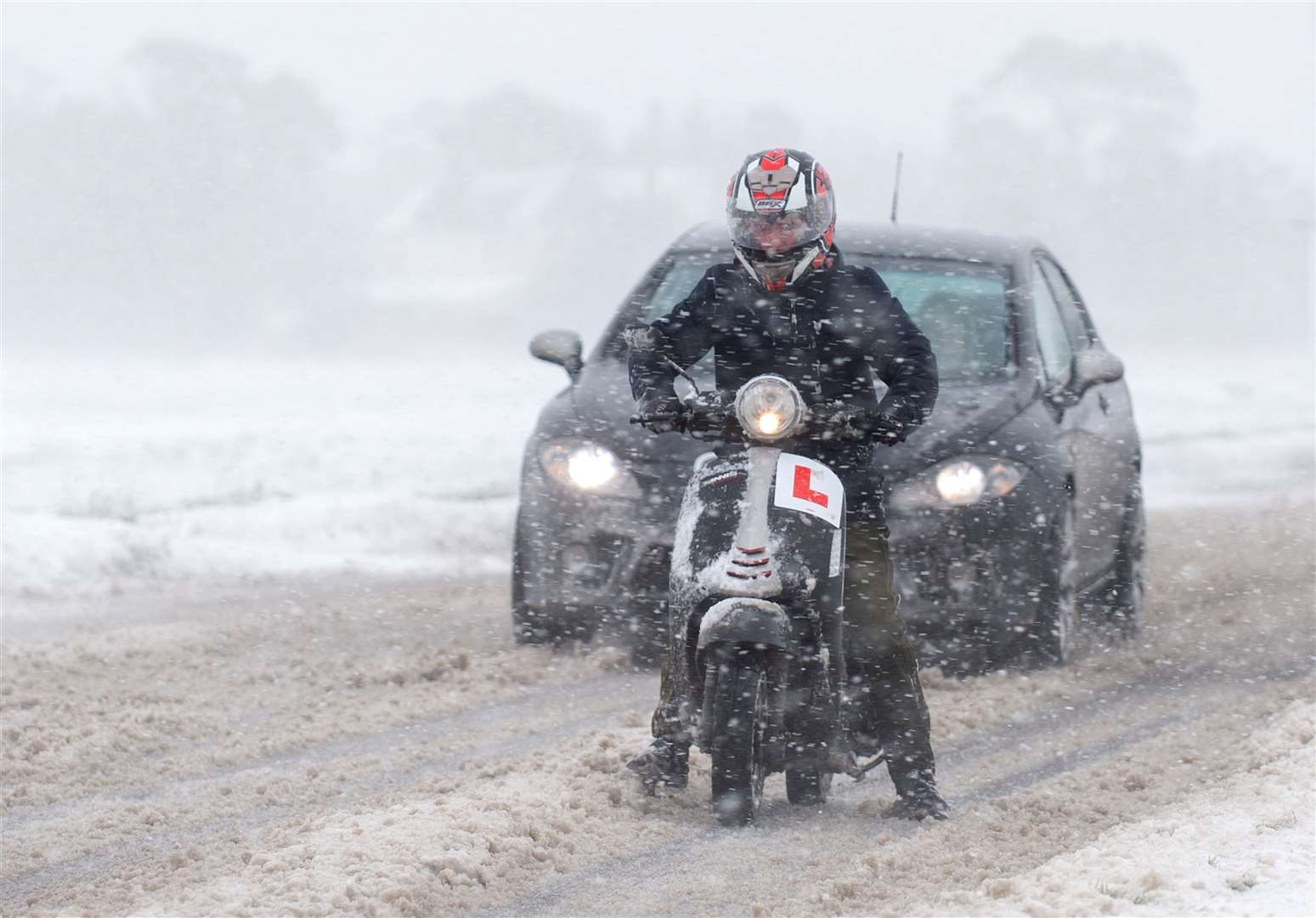 Vehicles make their way through snow near Kirby Cross in Essex (Joe Giddens/PA)