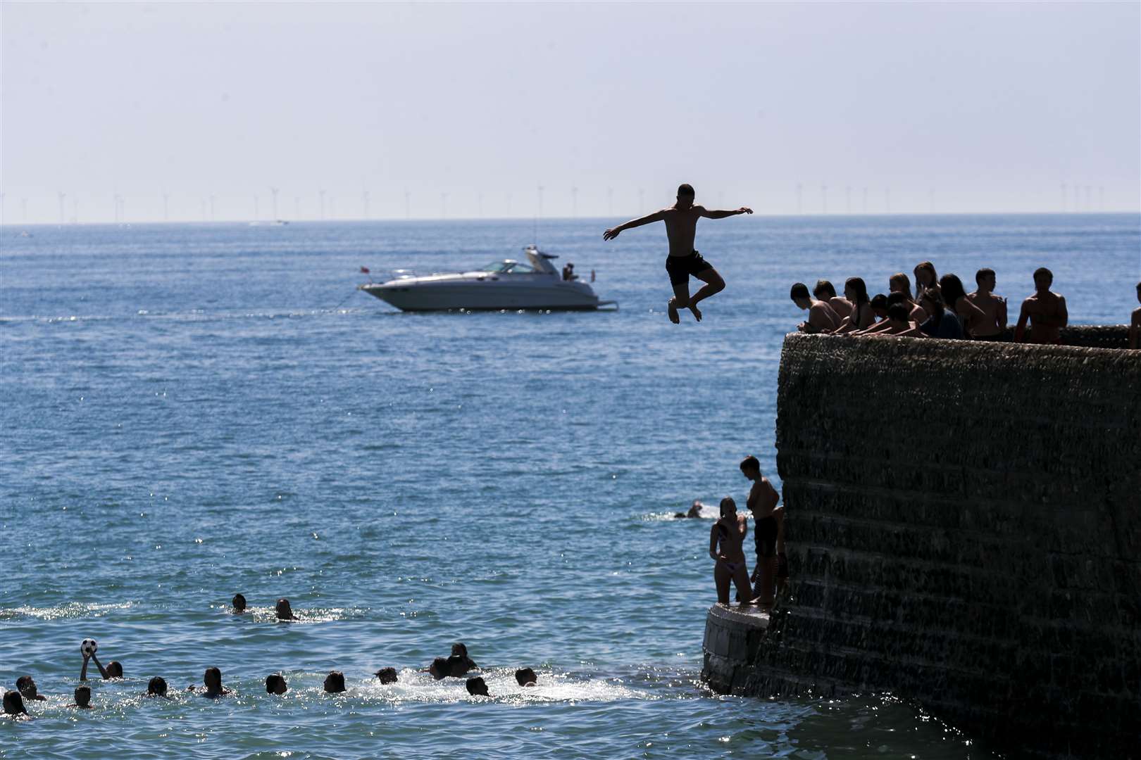 A man jumps into the sea at Brighton (Steve Parsons/PA)