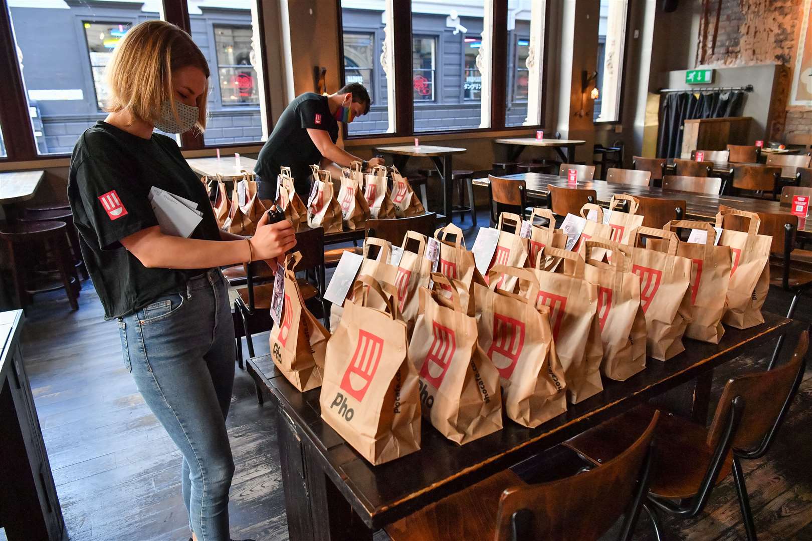 Staff prepare free lunch bags for collection at Pho in Bristol, who are providing free school meals for children over the half term holidays