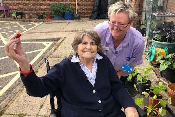 Staff member Jayne Springate and patient picking strawberries together. Picture: Sarah Pambour