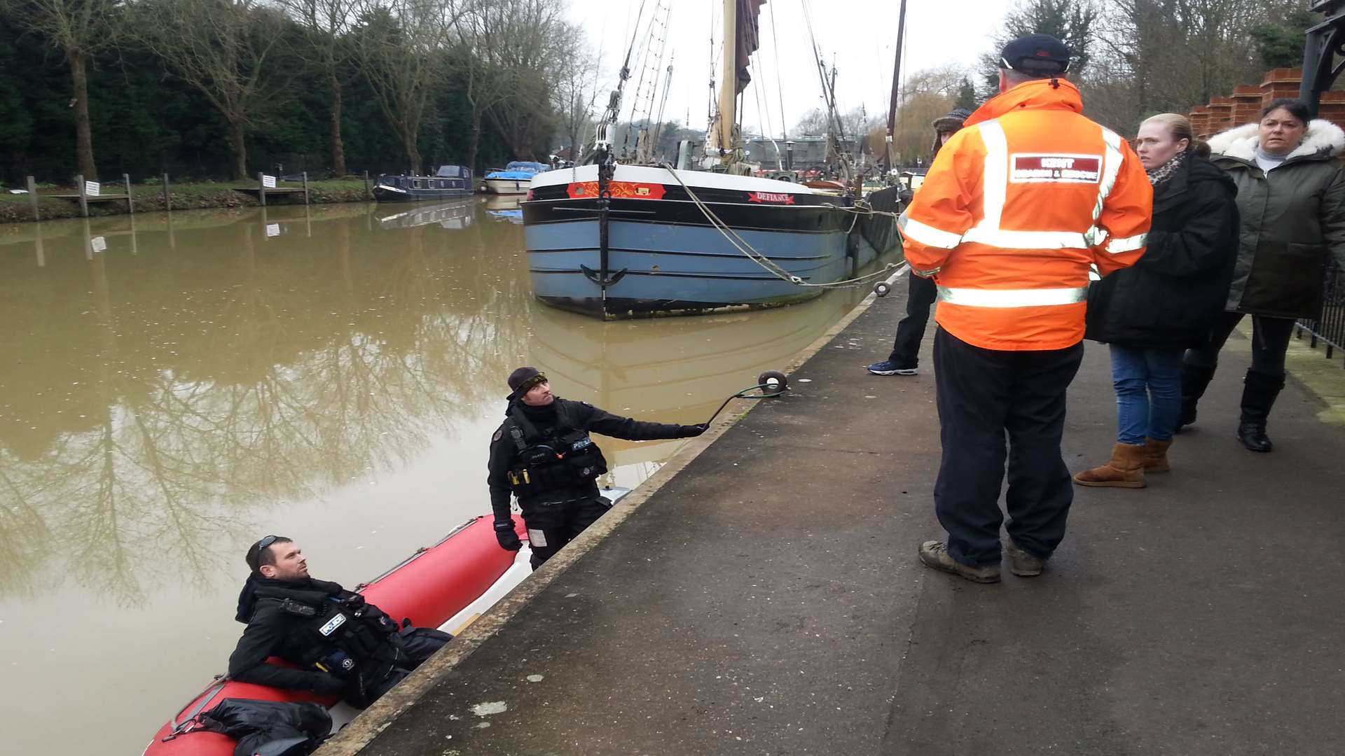 Police officers from the marine unit speak with Kent Search and Rescue's Steve McGowan and searchers looking for Pat Lamb