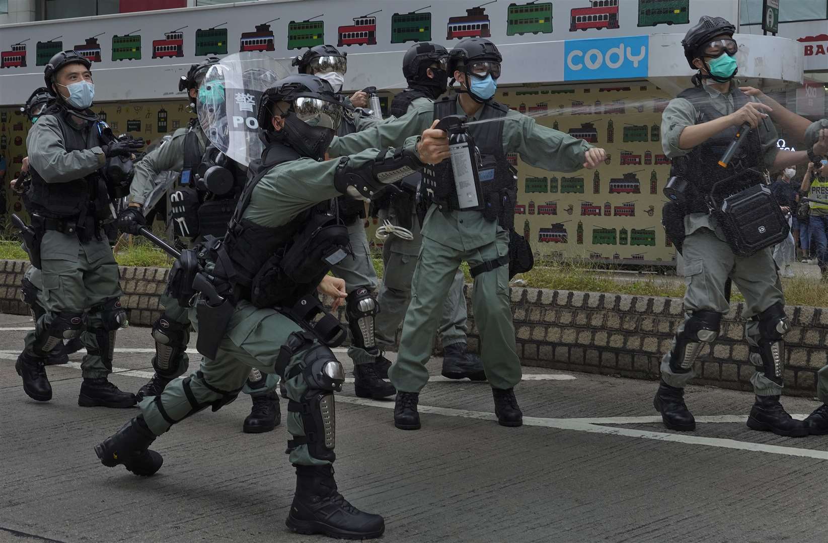 Riot police use pepper spray on protesters during a demonstration against Beijing’s national security legislation in Causeway Bay in Hong Kong (Vincent Yu/AP)