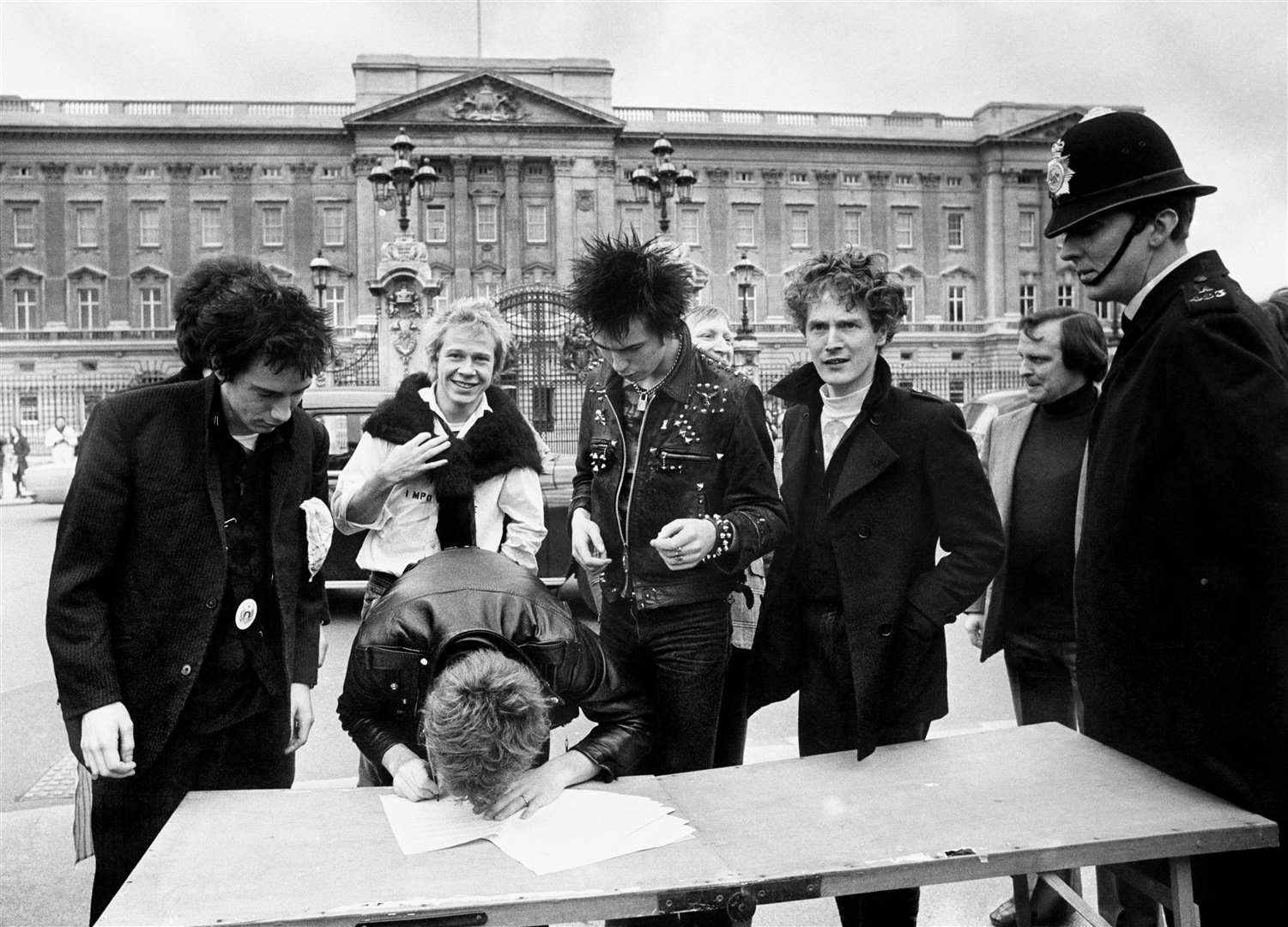 The Sex Pistols sign a new recording contract with A&M Records outside Buckingham Palace – (L to R) Johnny Rotten, Steve Jones, Paul Cook, bass player Sid Vicious and the band’s manager, Malcolm McLaren (PA)