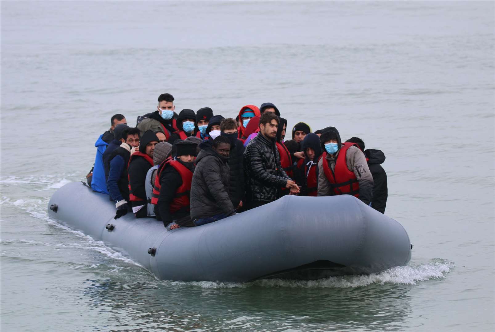 Asylum seekers landing on a beach in Kent. Stock image