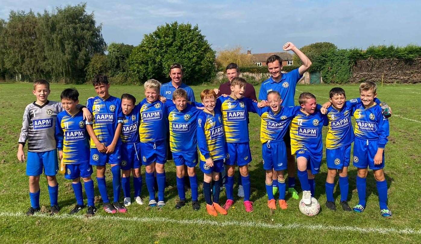 The winning team (left to right): Hayden, Mikey, Gabriel, Josh, Frank, Harvey, Zac, Kai, Kian, Buddy, Charlie and Theo. Coaches behind: Paul, Tim and Scott. Picture: Vicky Holt