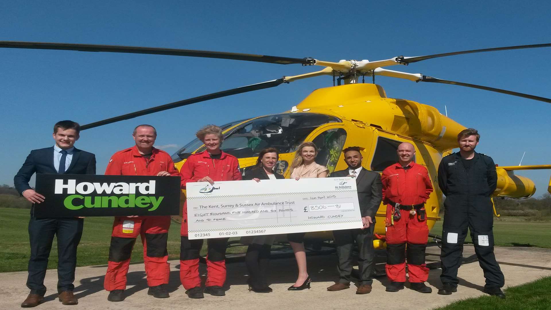 Staff at Howard Cundey’s Reigate office pictured at the Air Ambulance base at Redhill