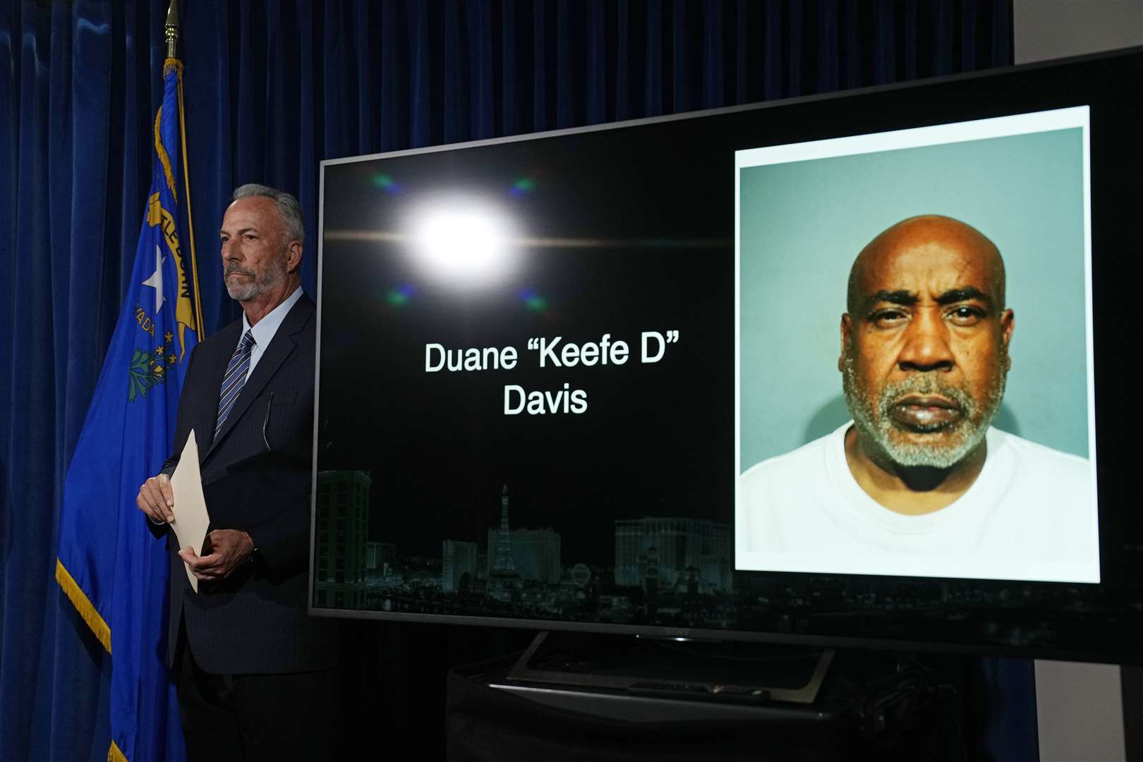 Clark County district attorney Steve Wolfson stands beside a photo of Duane Davis (John Locher/AP)