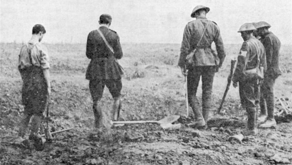 Army chaplain conducting a burial service in the field