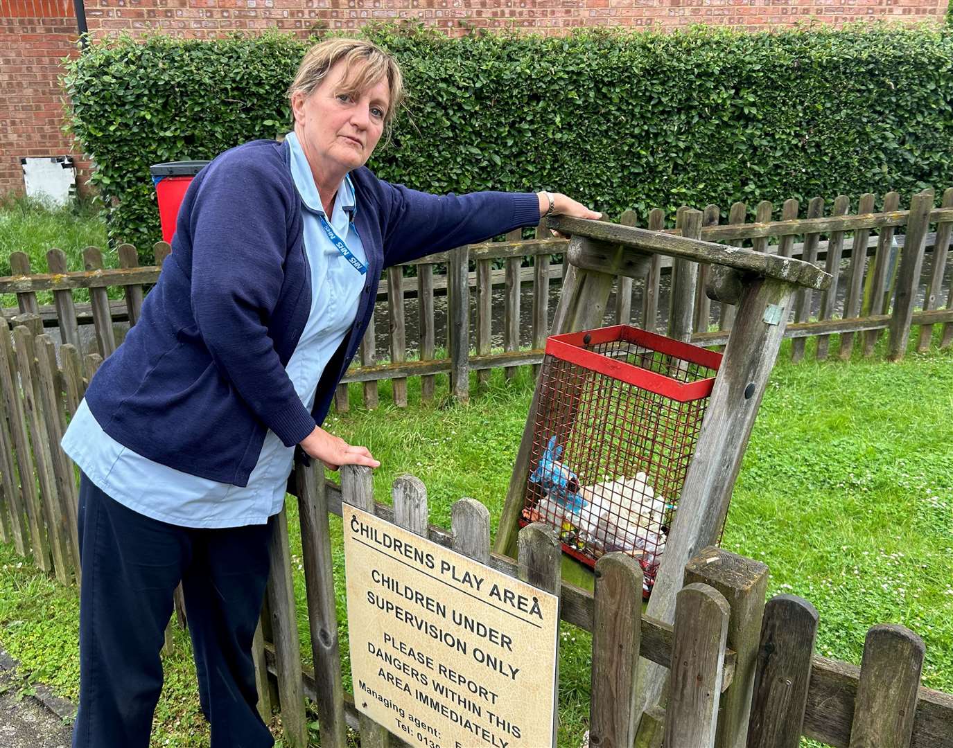 Christine Curtis with a broken bin in one of the play areas