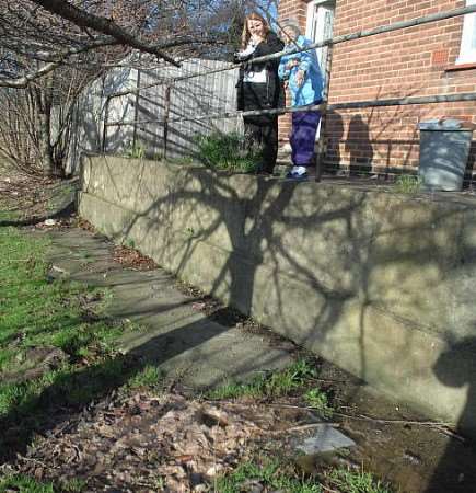 Daisy Bevan, 81, shows reporter Lynn Cox the leaking sewage. Picture: BARRY CRAYFORD