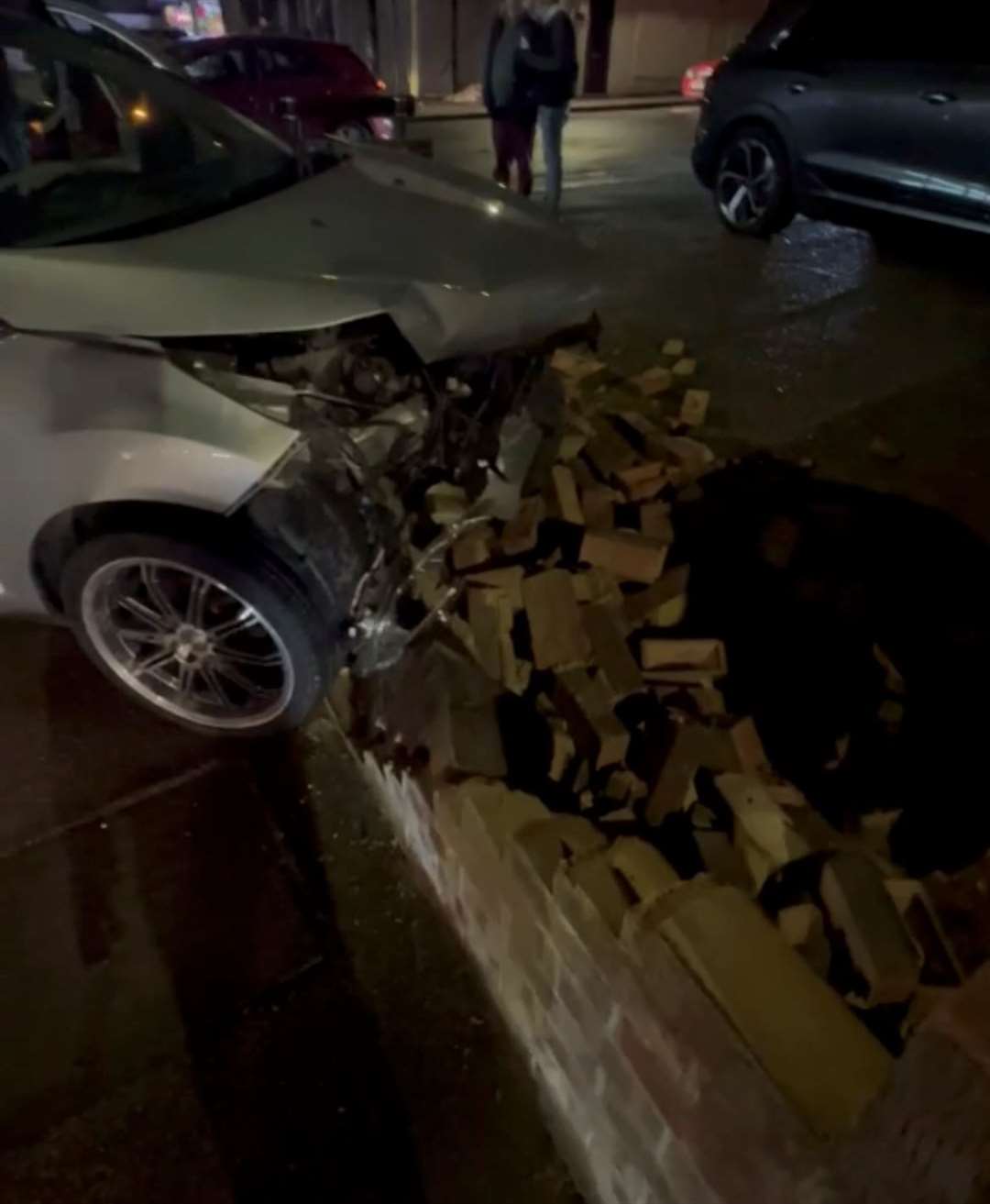 One of the cars ended up crashing into a brick wall