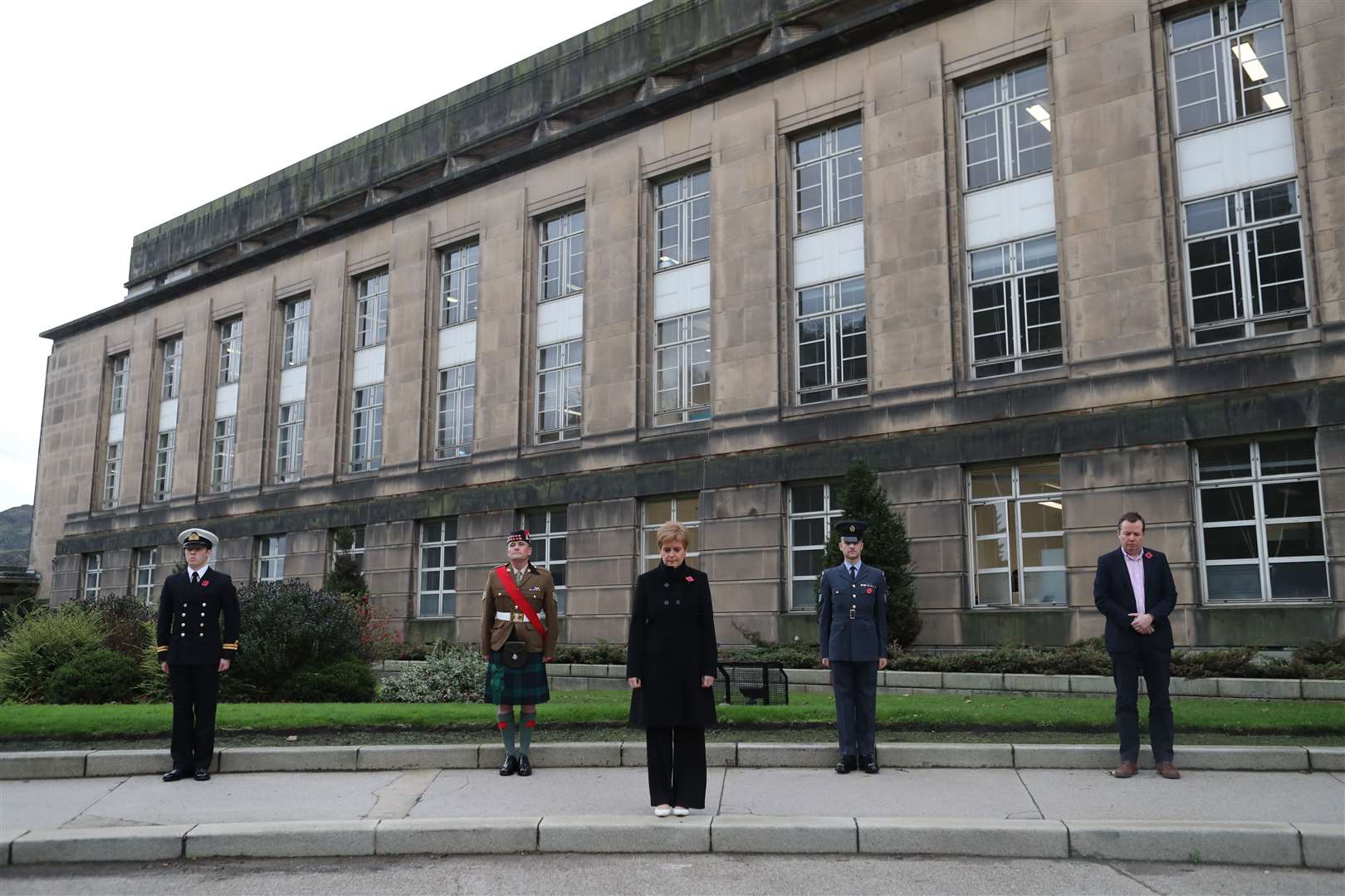 First Minister Nicola Sturgeon (centre) observes the two-minute silence (Jane Barlow/PA)