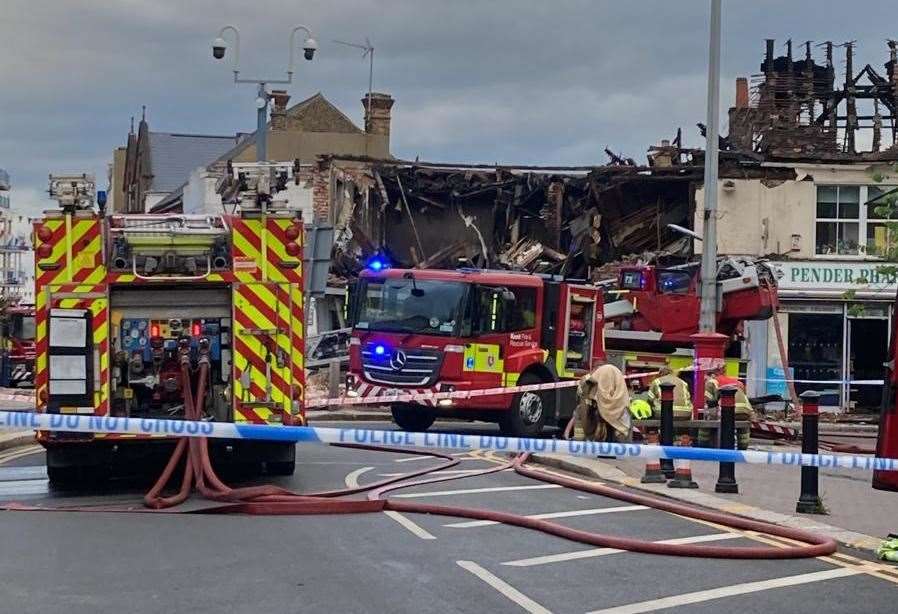 The front of the building has collapsed into the street