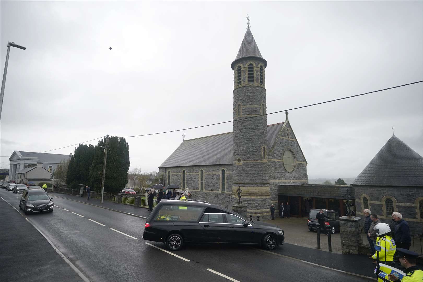 The funeral cortege arrives for the Requiem Mass (Niall Carson/PA)