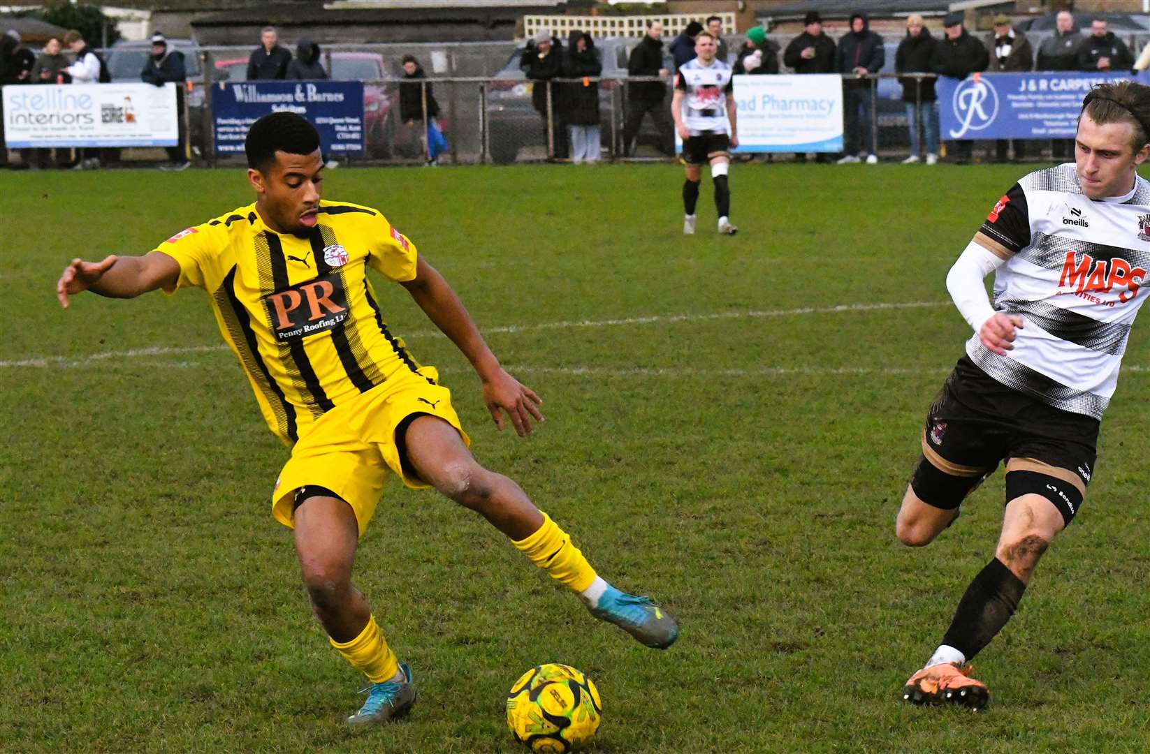 Sheppey defender Mamadou Diallo keeps the ball away from Deal debutant Tommy Lamb. Picture: Marc Richards