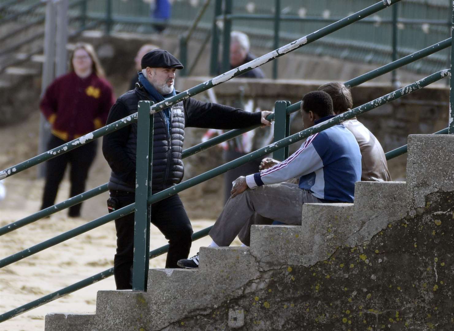 Director Sam Mendes talks to star Michael Ward on the steps leading down to the beach at Margate. Picture: Barry Goodwin