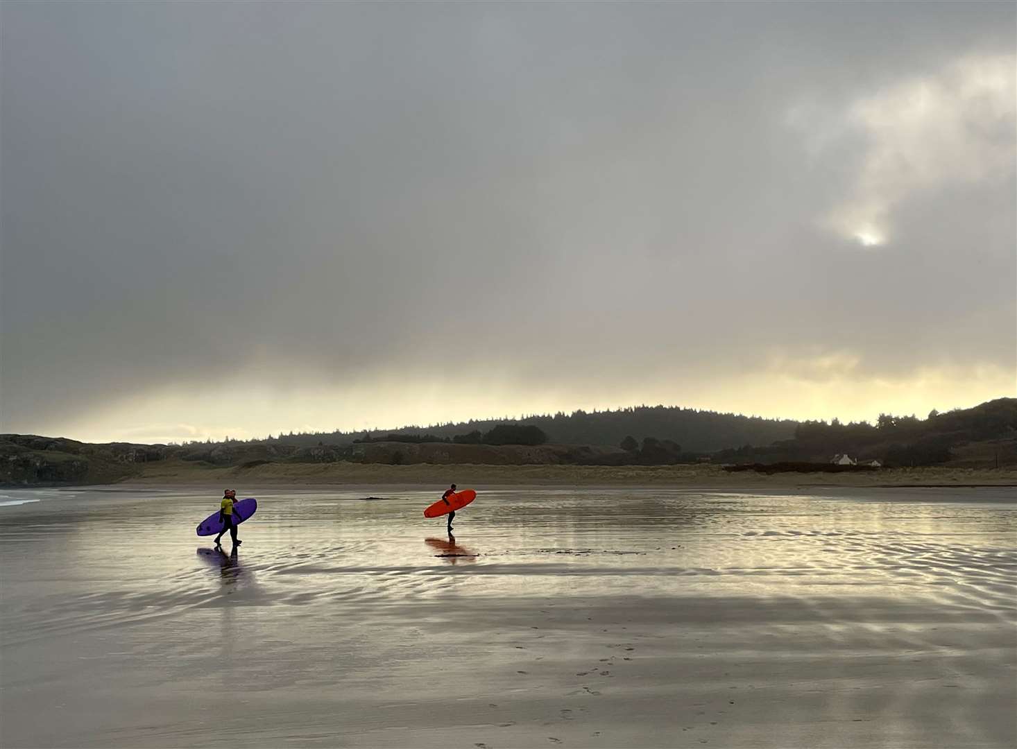 Weather warnings have also been issued in Ireland. Here, surfers enjoy the water at Marble Hill Strand beach near Dunfanaghy, Co Donegal, while they can (David Young/PA)