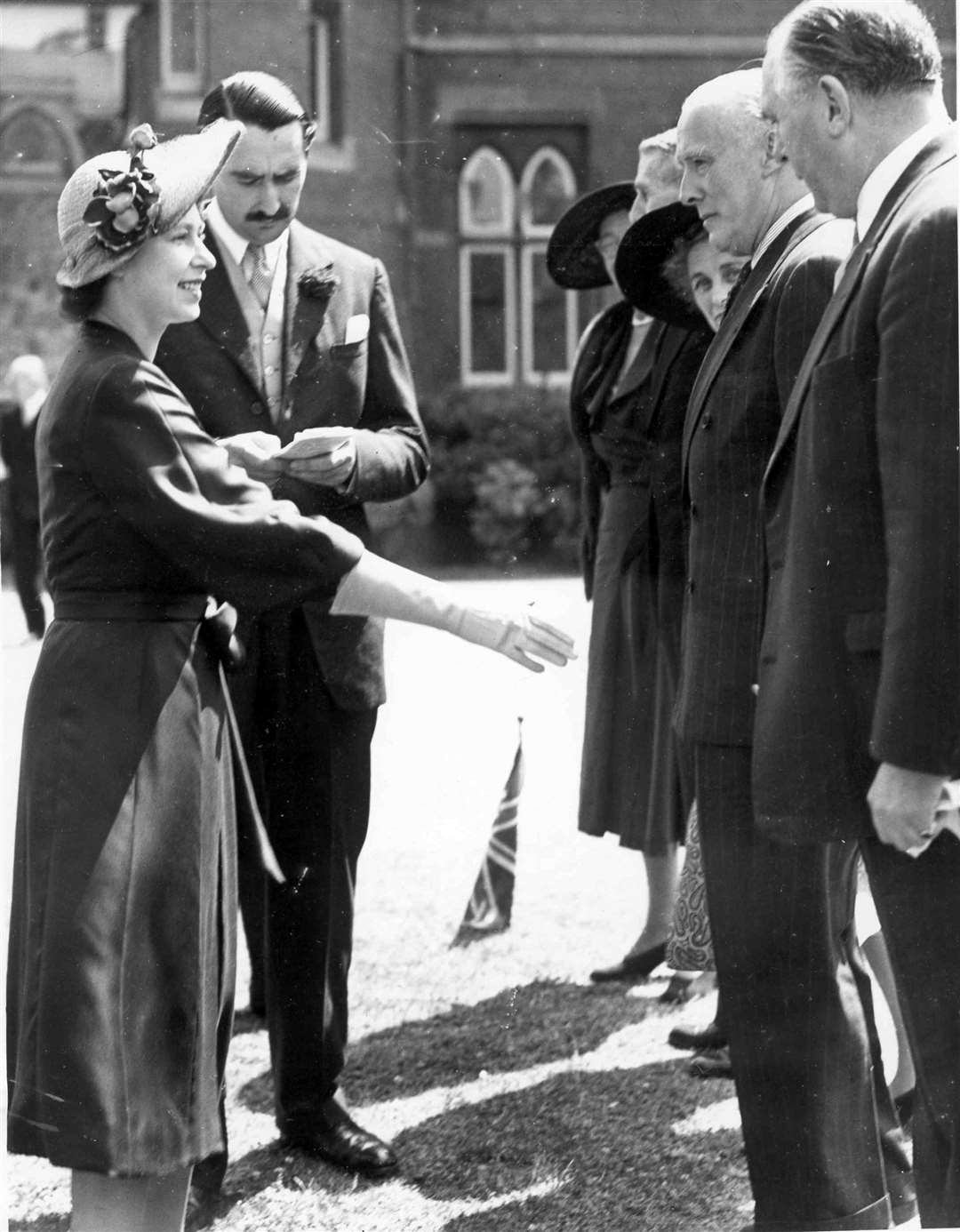 Huge crowds of holidaymakers greeted Princess Elizabeth as she was driven along the seafront at Margate in July 1951 on her way to the Royal School for Deaf and Dumb Children in the town. Here the Princess is seen being introduced to members of the school's committee by its treasurer, Lord Ebury