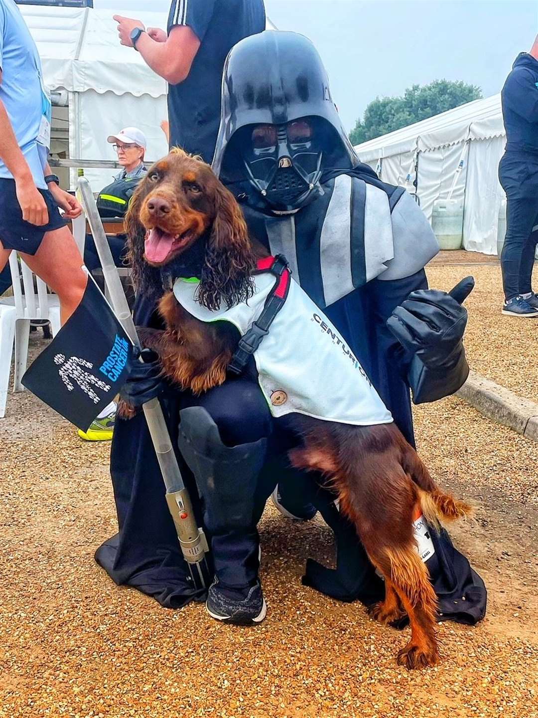 Simon Best, dressed as Darth Vader, meets a dog at a previous fundraising run (Simon Best/PA)