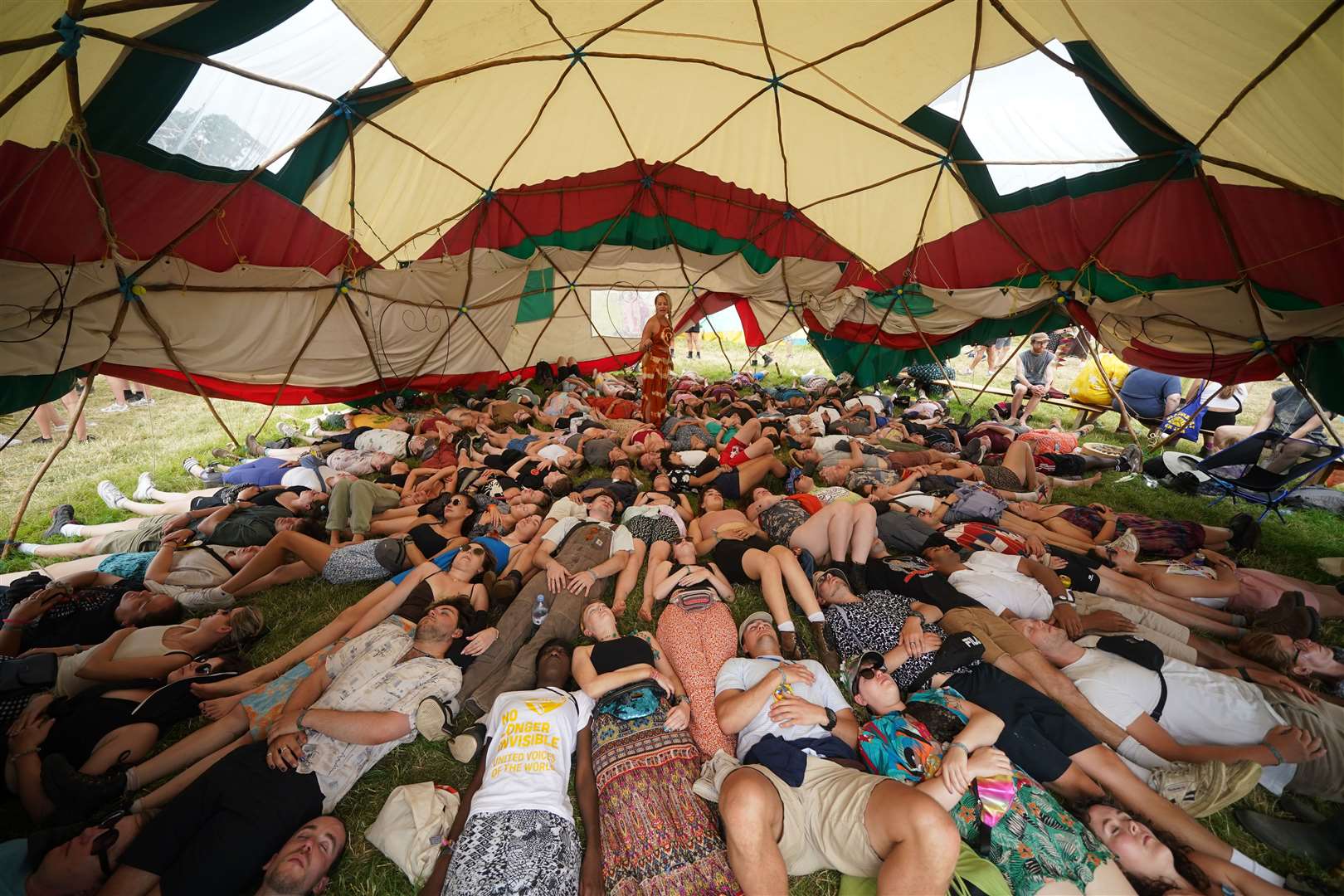 Festival-goers take part in a laughter yoga workshop in the Healing Field during the Glastonbury Festival at Worthy Farm in Somerset (Yui Mok/PA)