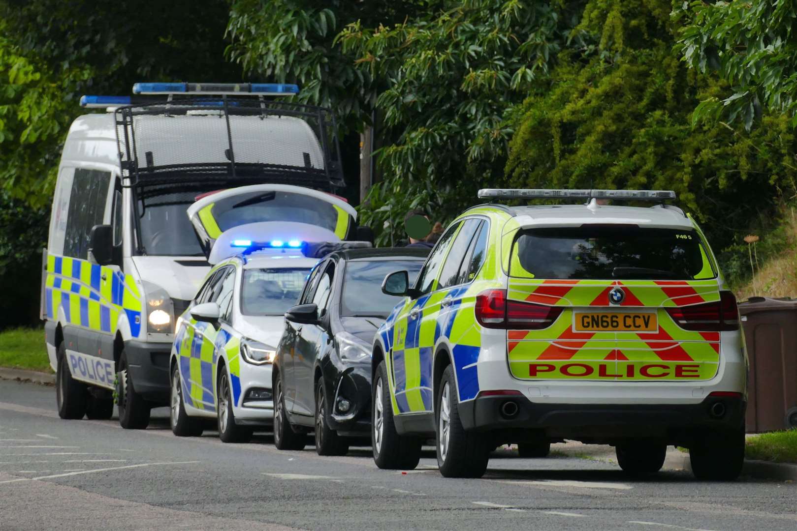 Police surrounding the car in Willesborough Road. Pic: Andy Clark