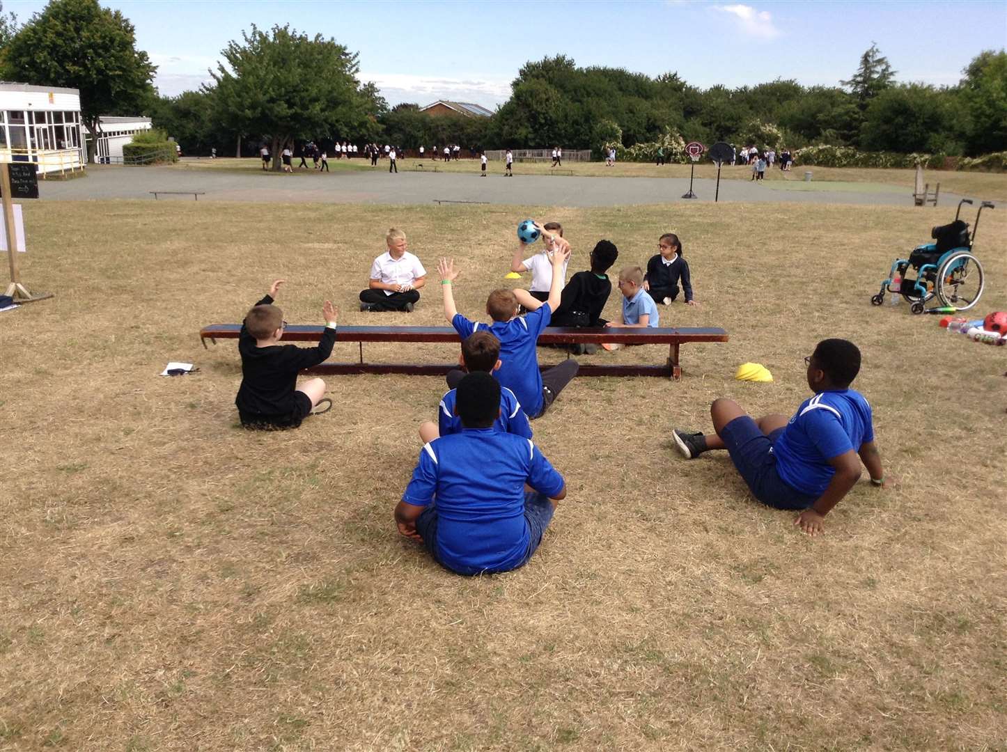 Pupils playing sit-down volleyball