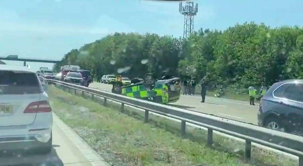 An ambulance has flipped over and four other cars are damaged. Photo: Korina Jones