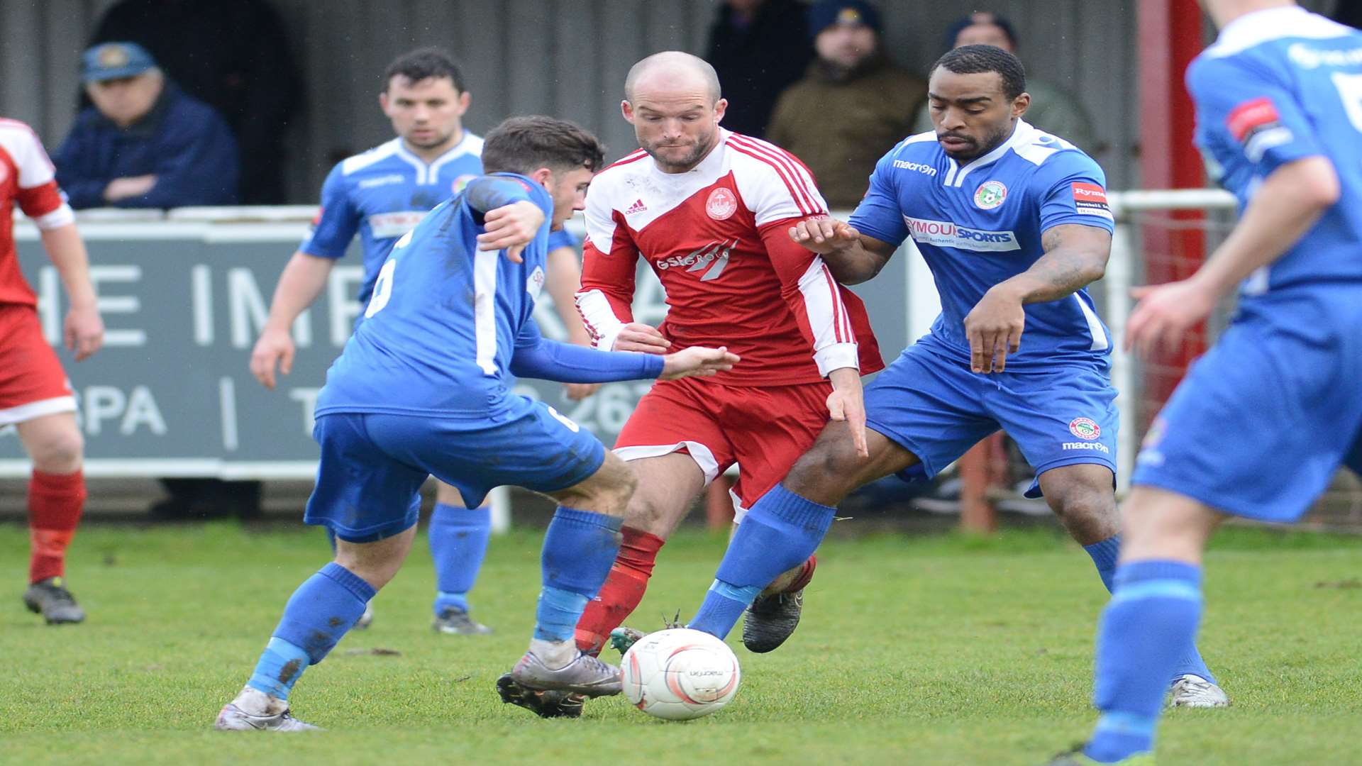 Hythe's Darren Marsden tries to get between two Dorking Wanderers players Picture: Gary Browne
