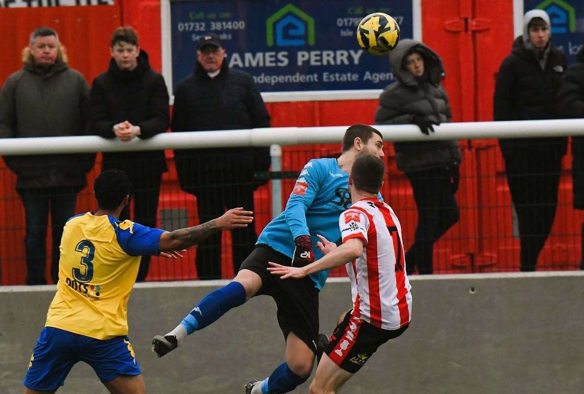 Faversham keeper Bailey Vose gets to the ball ahead of Sheppey winger Danny Leonard in Saturday's 2-2 draw. Picture: Marc Richards