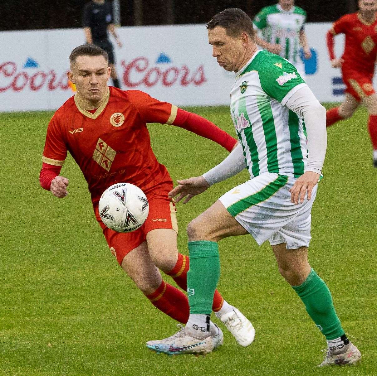 Whitstable midfielder Josh Oliver (red) comes up against VCD’s Charlie Heatley during their Kent Senior Trophy second round clash Picture: Les Biggs