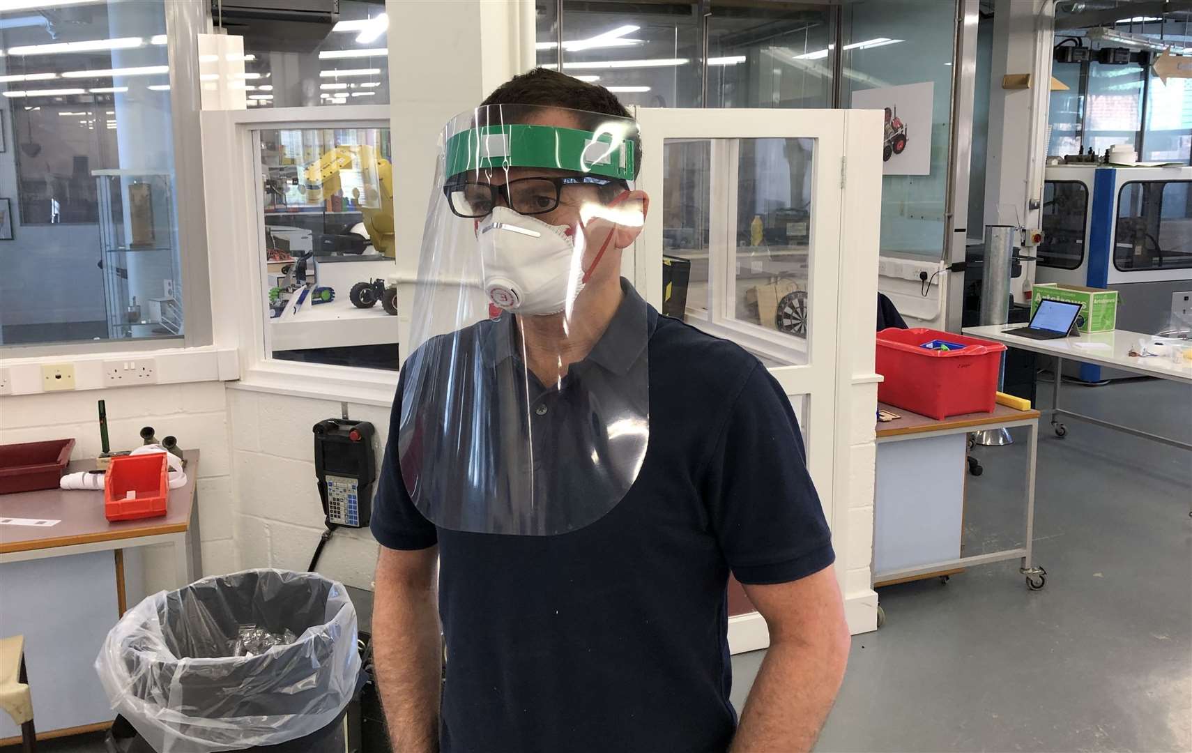 Tonbridge teacher Will Biddle wearing one of the newly produced protective masks in the school's design technology lab