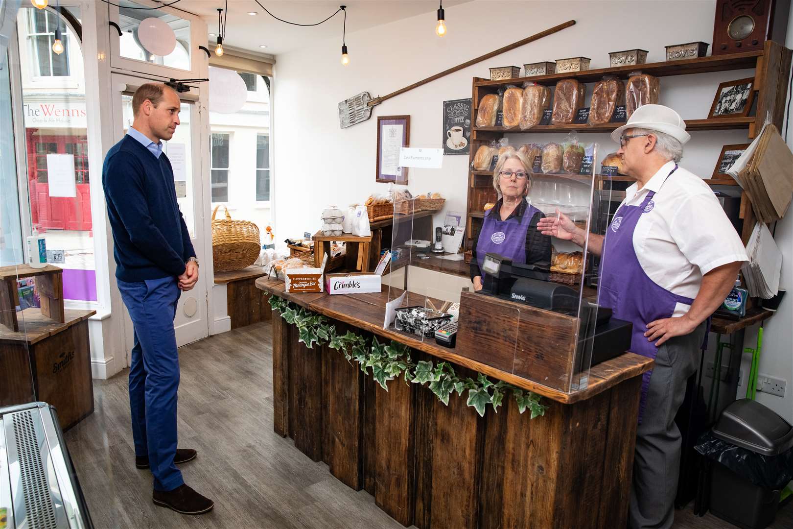 William chatting to bakery owners Paul and Teresa Brandon (Aaron Chown/PA)