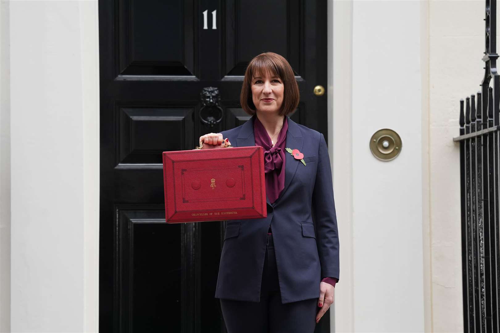 Chancellor of the Exchequer Rachel Reeves poses outside 11 Downing Street with her ministerial red box before delivering her Budget in the Houses of Parliament (Lucy North/PA)