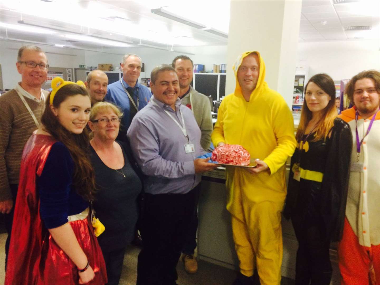 Prospective bakers at North Kent College pose with one of the bake-off's more creative cakes.