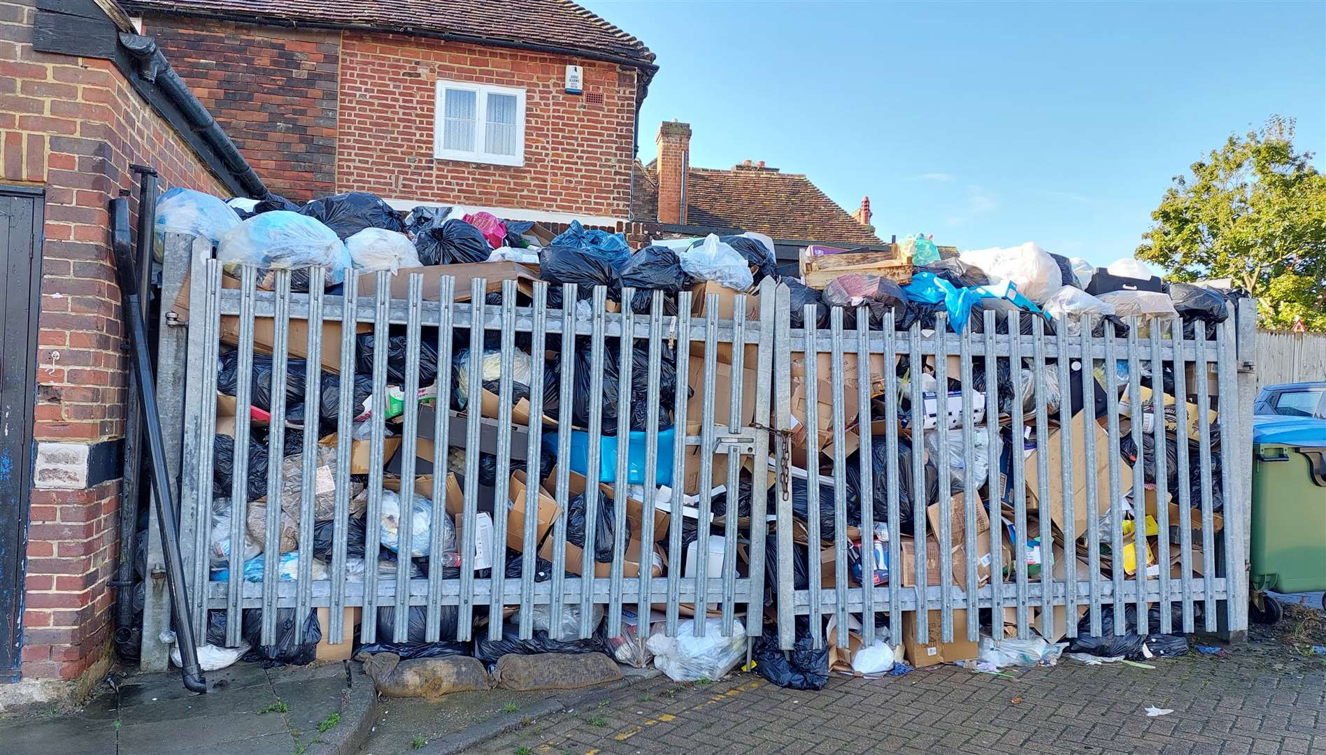 Rubbish bags are piled high at the back of Park Mall shopping centre