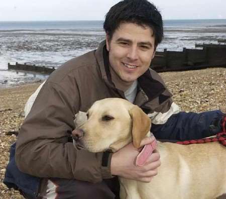 BACK HOME: Hollie with owner Graham Wiles after a paddle in the sea at Whitstable. Picture: CHRIS DAVEY