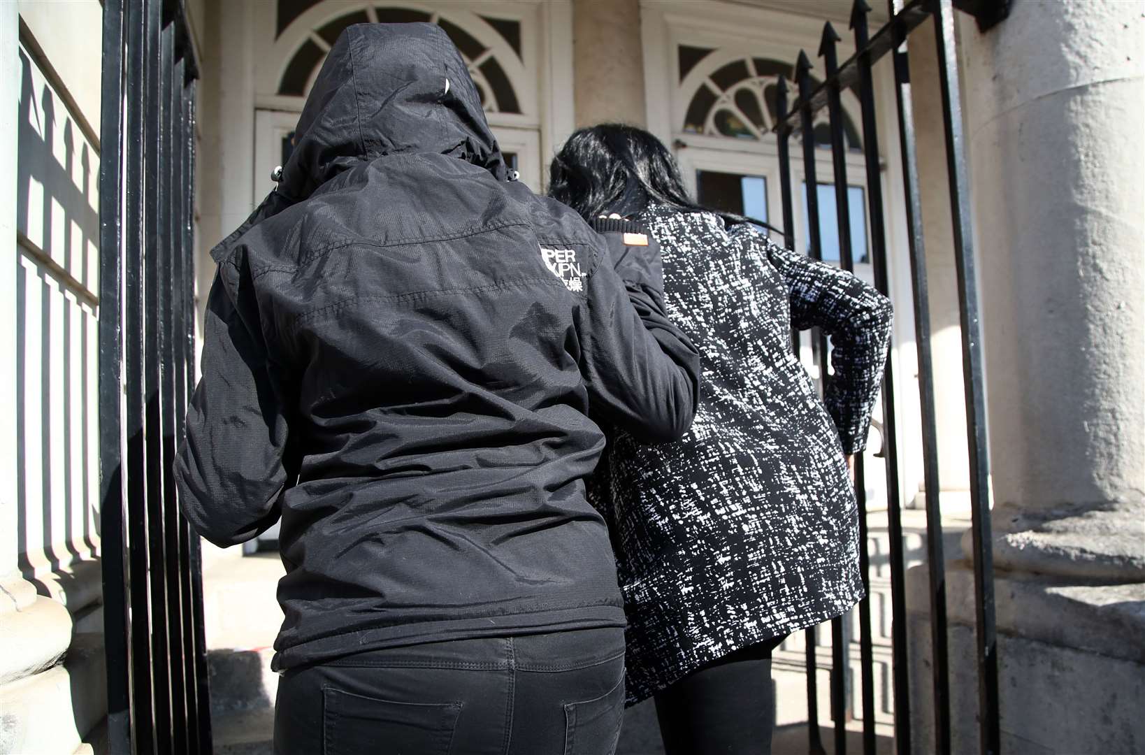 Jennifer Johnson (right) the ex-girlfriend of Babes in the Wood murderer Russell Bishop, is bundled into Lewes Crown Court (Gareth Fuller/PA)