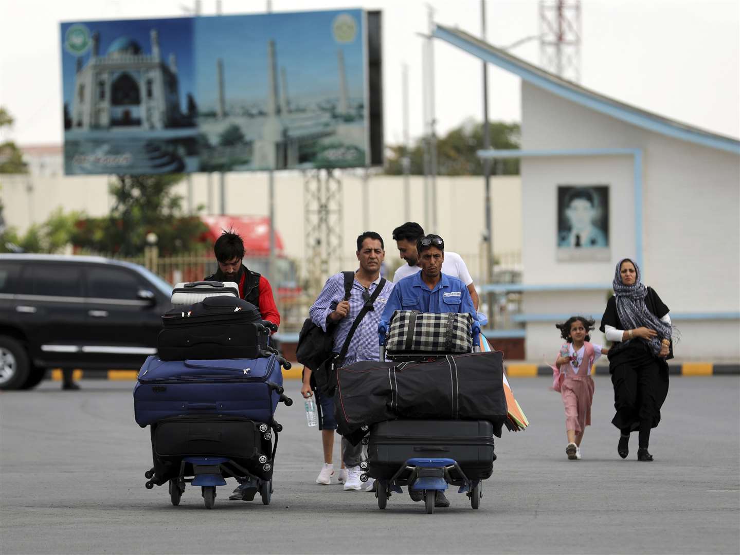 Passengers walk to the departures terminal at Hamid Karzai International Airport in Kabul (Rahmat Gul/AP)