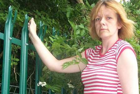 David McRae's mother Amanda, examines the fence where the incident happened. Picture: PETER COOK