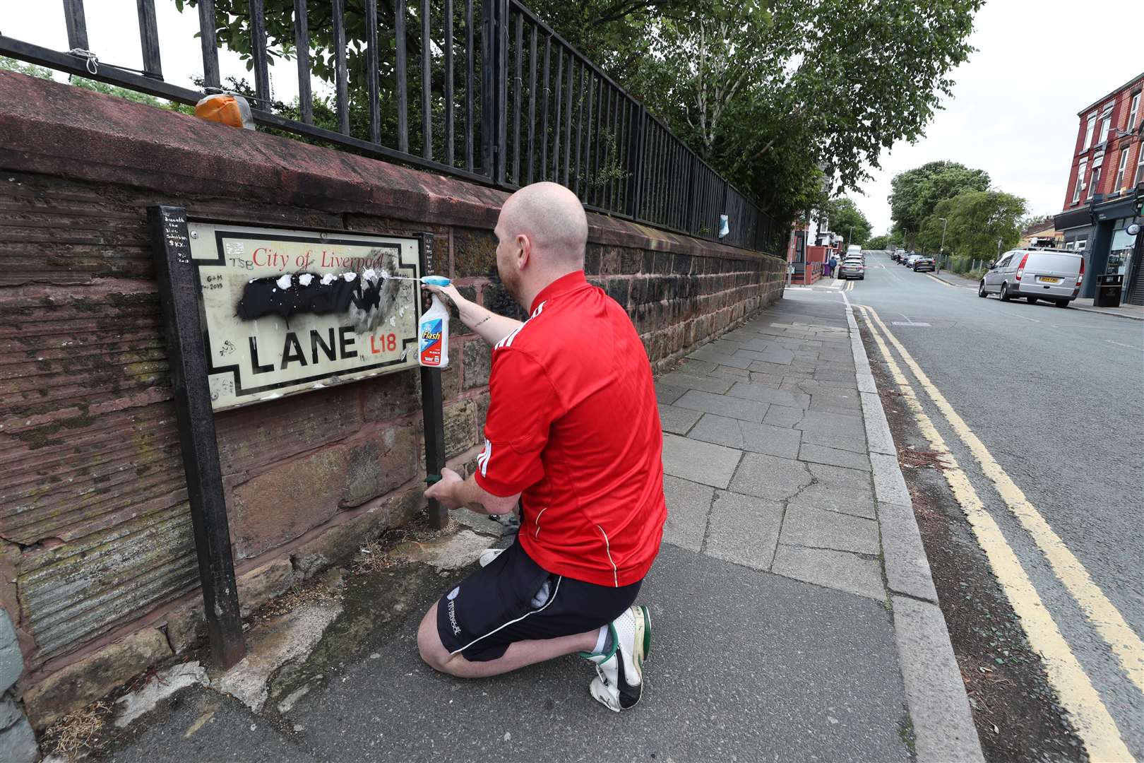 Emmett O’Neill cleans a road sign for Penny Lane (Peter Byrne/PA)