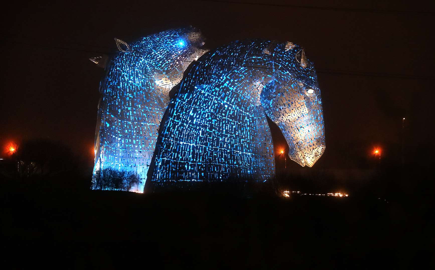 The Kelpies in Falkirk are lit up in blue in a weekly gesture of thanks to the hardworking NHS staff trying to battle coronavirus (Andrew Milligan/PA)