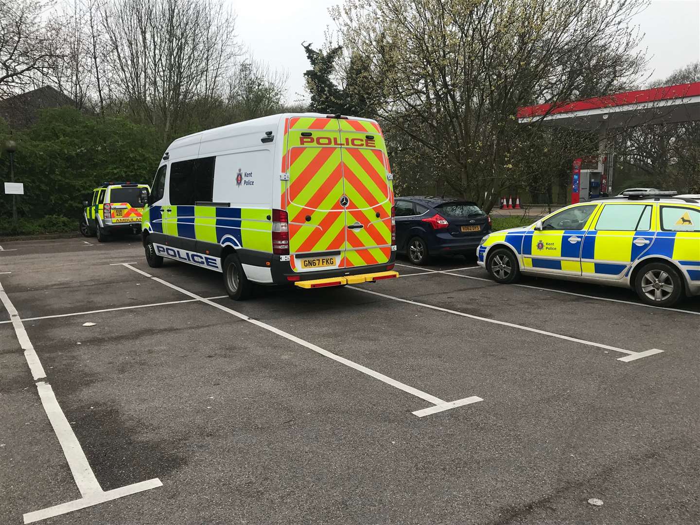 Police at the Esso Garage, near the Brotherhood Wood caravan site on the A2 in Dunkirk